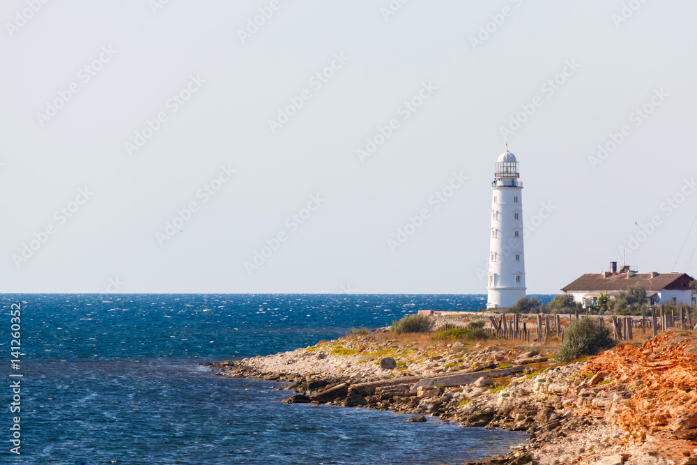 white lighthouse on the background of the sea