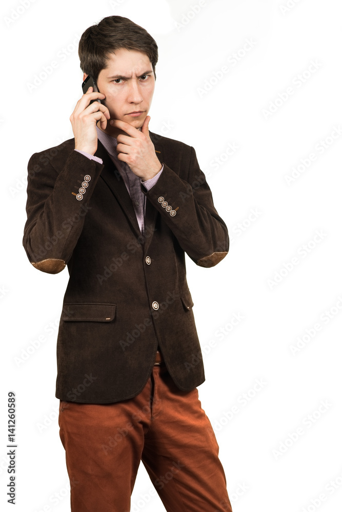Portrait of a young pensive businessman talking on cell phone Portrait of a young pensive businessman talking on cell phone