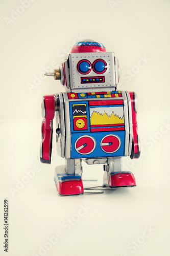 Filtered vintage tin toy robot isolated on white background