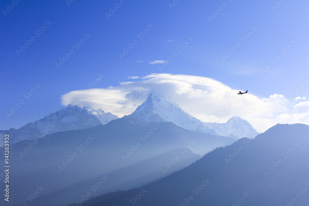 Helicopter and Annapurna mountain range, view from Poonhill famous trekking destination in Nepal.