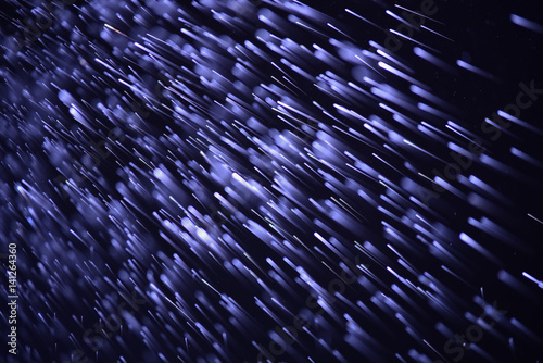 defocused abstract blue lights with falling rain background