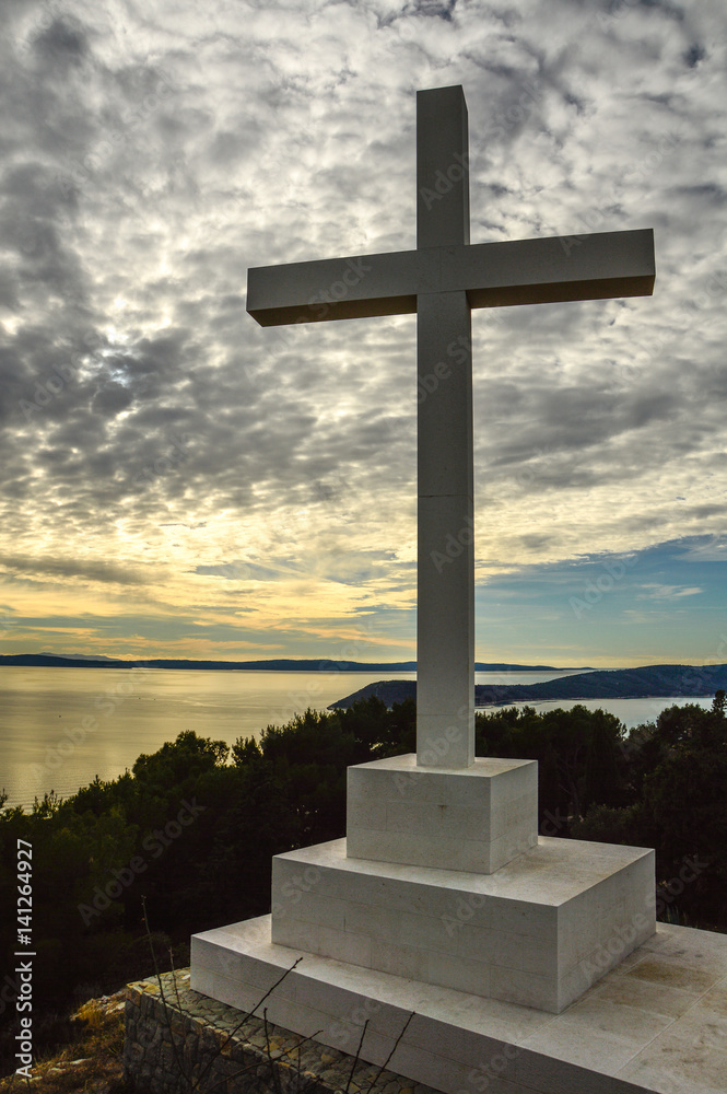 High Concrete crucifix on the top of the mountain above the shore in Split, Croatia High Concrete crucifix on the top of the mountain above the shore in Split, Croatia