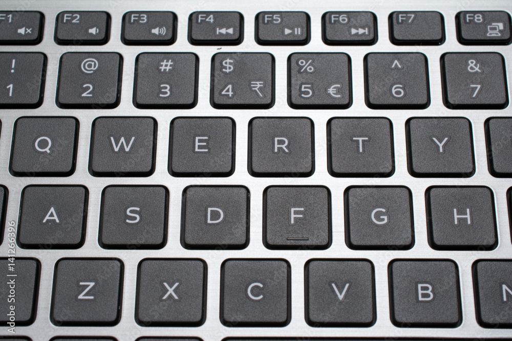 Modern laptop QWERTY keyboard closeup