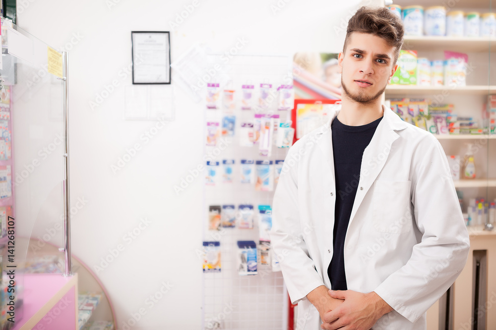 Pharmacist man at work looking in camera