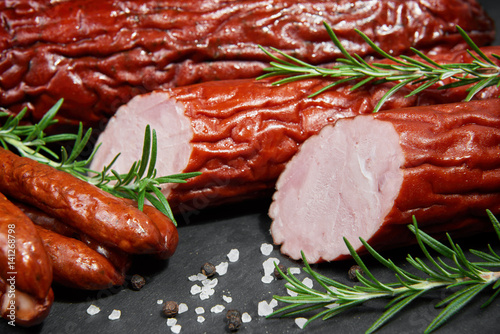 Set of cold cuts on a wooden board. Mix of sausages