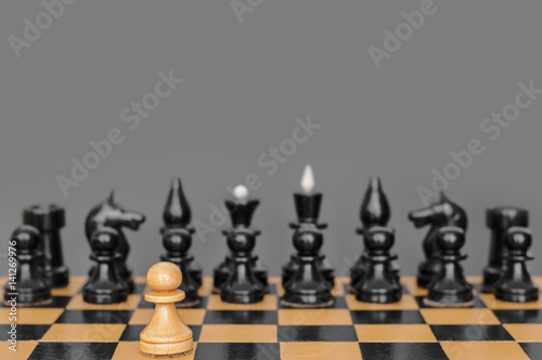 Party in chess  the first move with a white pawn. On a gray background