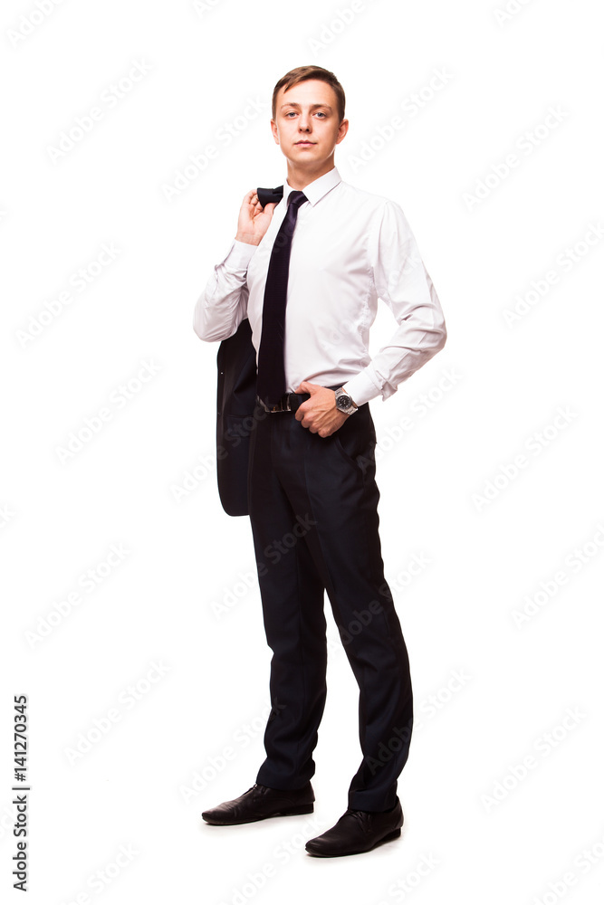 Young handsome businessman is holding a jacket in his one hand and the other hand in his pocket. portrait isolated on white background Young handsome businessman is holding a jacket in his one hand and the other hand in his pocket. portrait isolated on white background