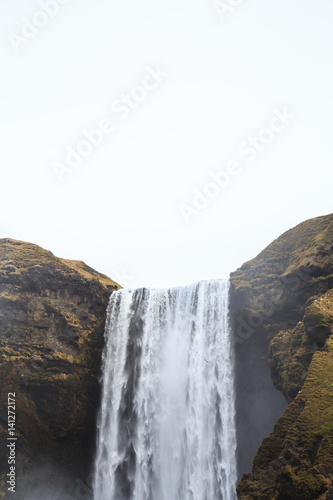 Skógafoss waterfall in southern Iceland on a cloudy winter day. 