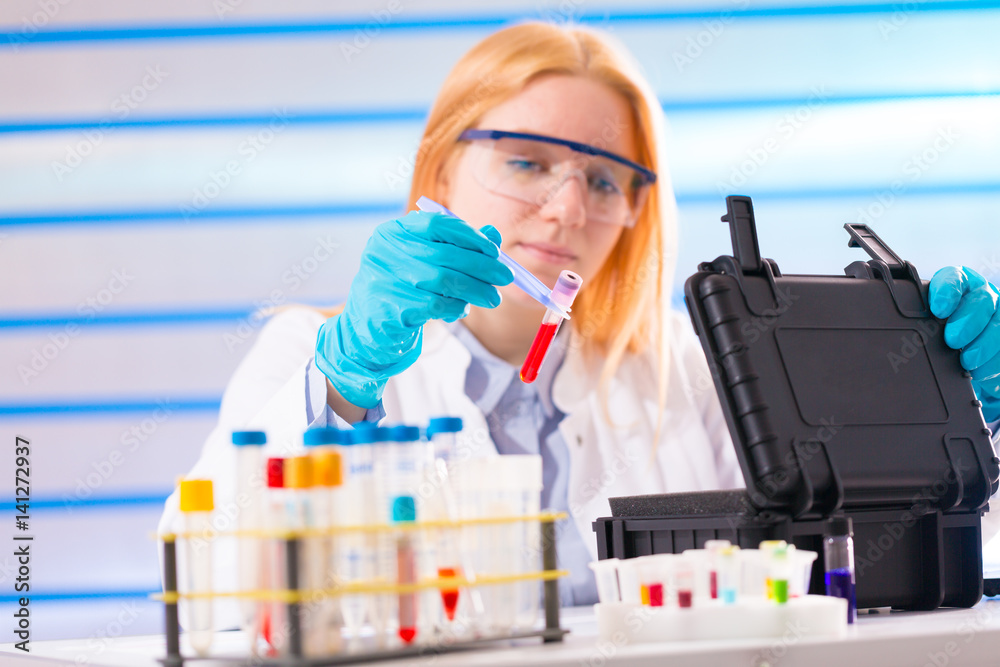 Laboratory assistant in a laboratory with a toxic biological sample in test tube Laboratory assistant in a laboratory with a toxic biological sample in test tube