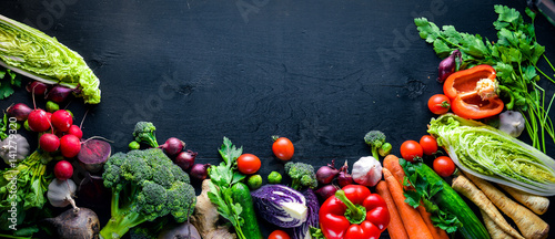 Big set organic food. Fresh raw vegetables. On a black chalkboard.