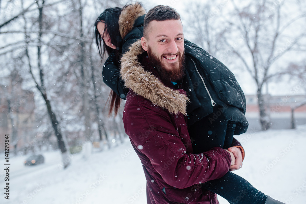Fototapeta premium Young couple having fun on the snow