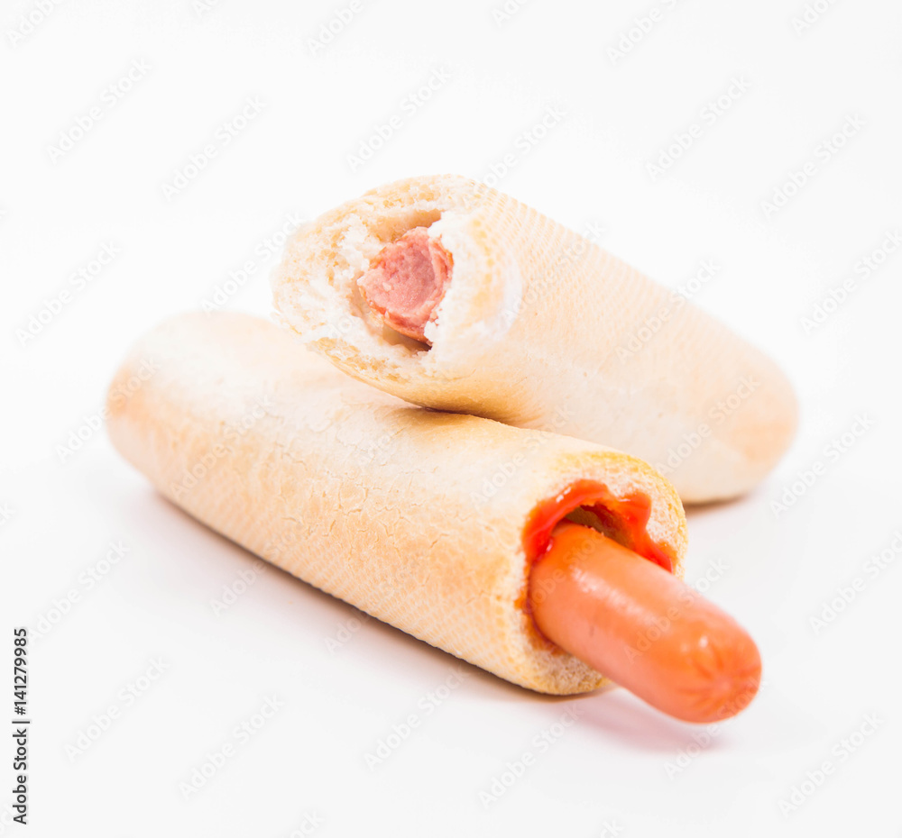 Hot dogs on a white background, one bitten Hot dogs on a white background, one bitten
