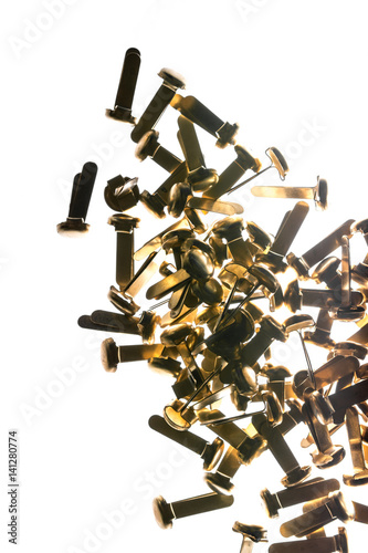 Stack of office supplies brass fasteners paper clips isolated on white