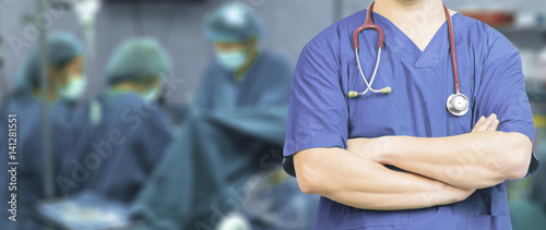 Photos Medical ,Doctor surgeon posing with arms crossed in an operating theatre,surgic