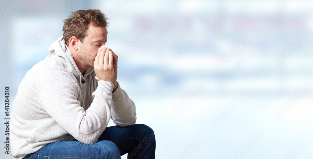 sneezing man with cold