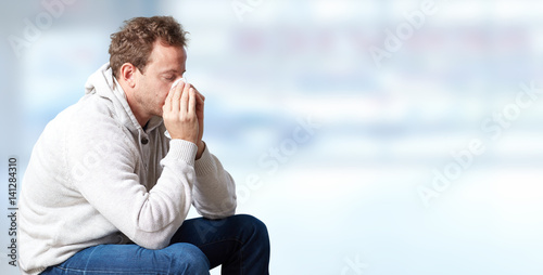 sneezing man with cold