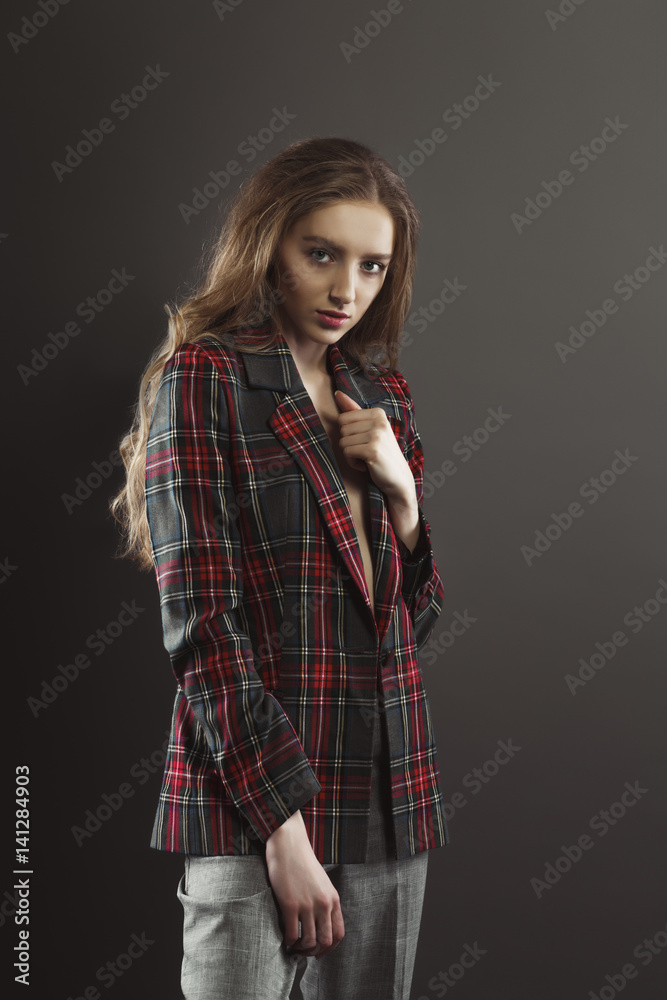 Attractive young woman posing for model tests in tartan jacket Attractive young woman posing for model tests in tartan jacket