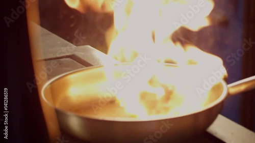 Cooking meat on fire in slow motion