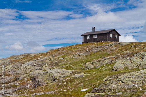 Traditional norwegian wooden house with solar panels in Norway mountains