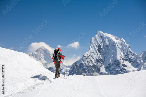 Trekker is walking by Renjo La pass in Everest region