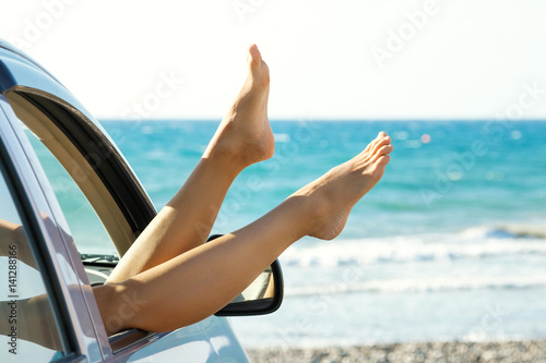 Female legs dangling from car window