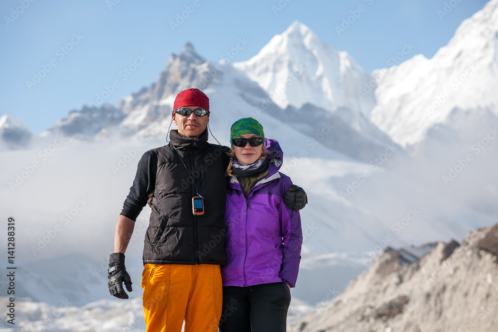 Trekkers are posing at camera in Khumbu valley on a way to Everest Base camp