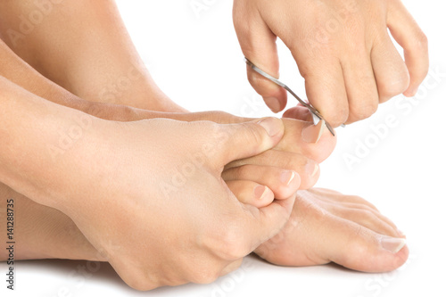 Female feet and nail scissors