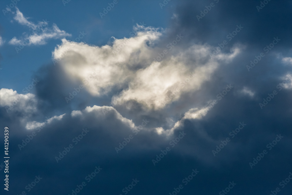 Clouds highlighted with the Sun in blue sky