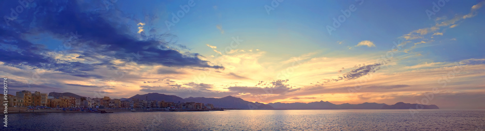 Colorful panoramic view of Sicily coastline with cloudy sunset sky, Mediterranean sea