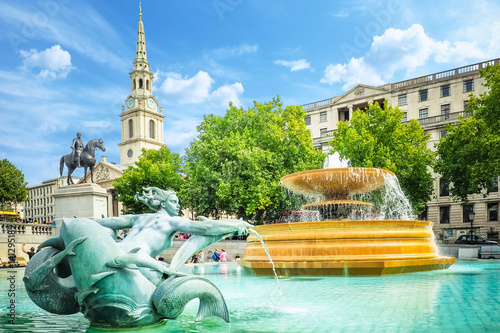 Fountains in the Trafalgar square on a bright summer day photo