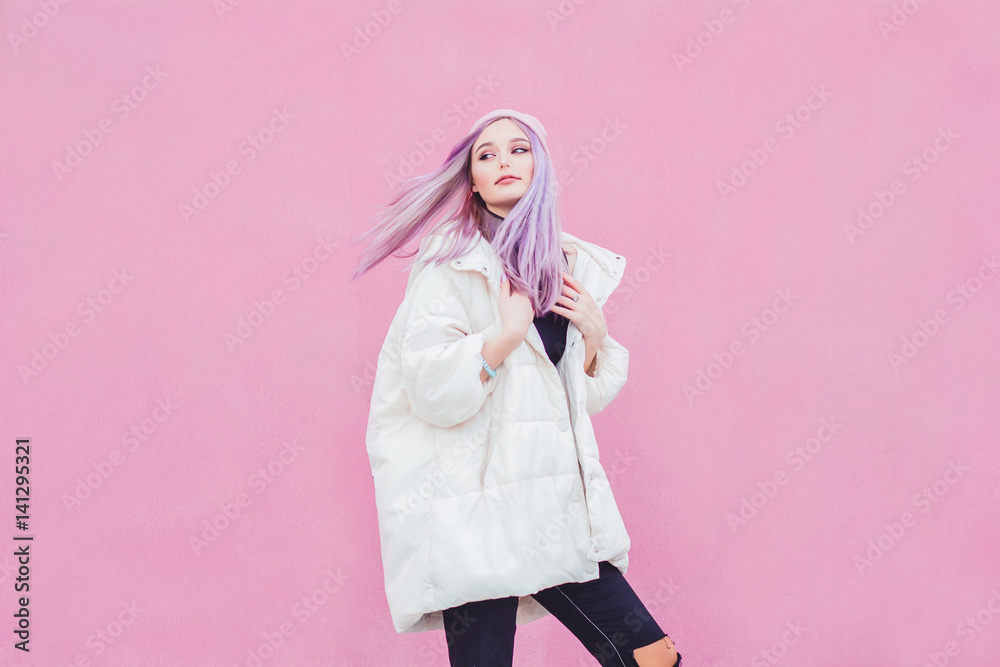 A beautiful girl with purple hair walks the streets of the city. Wearing a jacket, torn jeans and a hat. A beautiful girl with purple hair walks the streets of the city. Wearing a jacket, torn jeans and a hat.