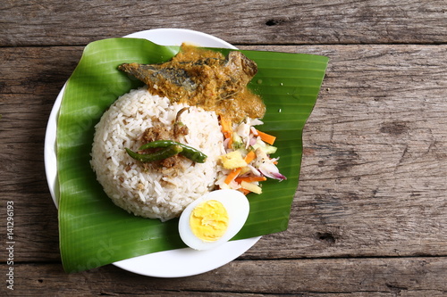 Nasi dagang, a popular Malaysian meal on the east coast of the Malaysian Peninsular. It consists of rice steamed in coconut milk, fish curry, hard boiled eggs and pickled vegetables.