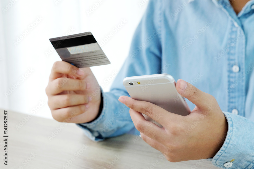 Woman hands using smart phone and holding credit card, shopping online concept, business and technology
Woman hands using smart phone and holding credit card, shopping online concept, business and technology