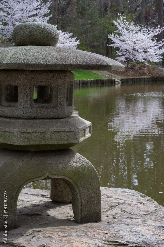 Japanese garden scene with cherry blossoms and stone sculpture. Sarah P. Duke botanical gardens.