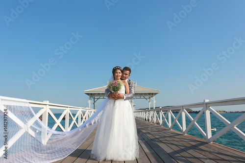 Pre Wedding photography thai couples on a wooden Atsadang bridge of Koh Si Chang Island at Thailand. photo