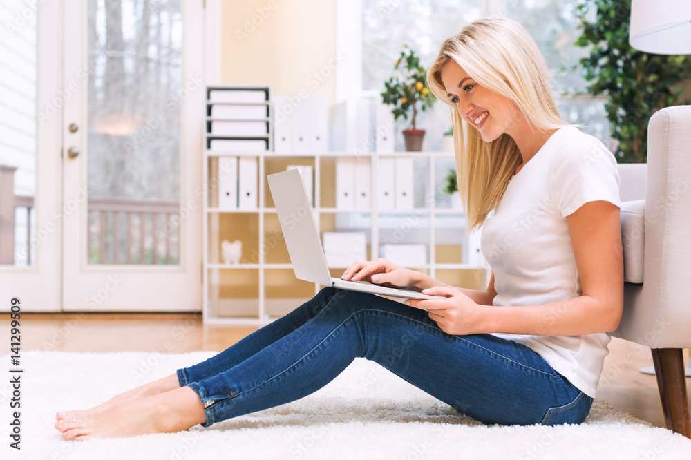 Happy young woman using her laptop Happy young woman using her laptop