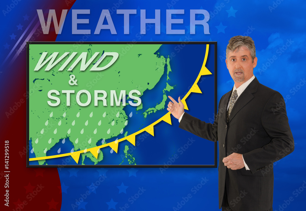 A tv television news weather man meteorologist anchorman is reporting with a Wind & Storm graphic over a map of Asia on the monitor screen. A tv television news weather man meteorologist anchorman is reporting with a Wind & Storm graphic over a map of Asia on the monitor screen.