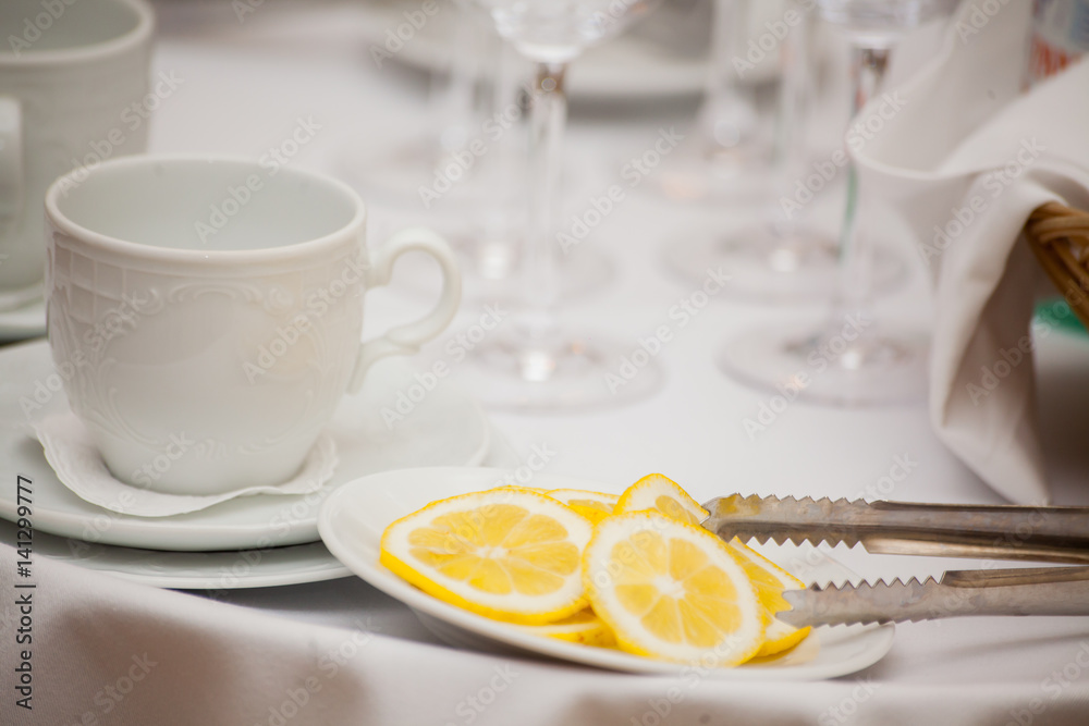 Cup of tea with lemon on table close-up. Cup of tea with lemon on table close-up.