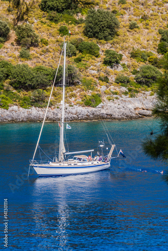 bareboat anchored in the bay,blue cruise