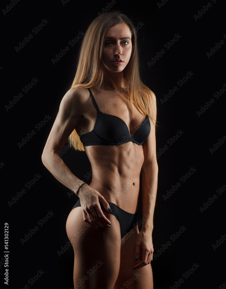 sexy fit woman in black lingerie isolated on black background Stock Photo |  Adobe Stock