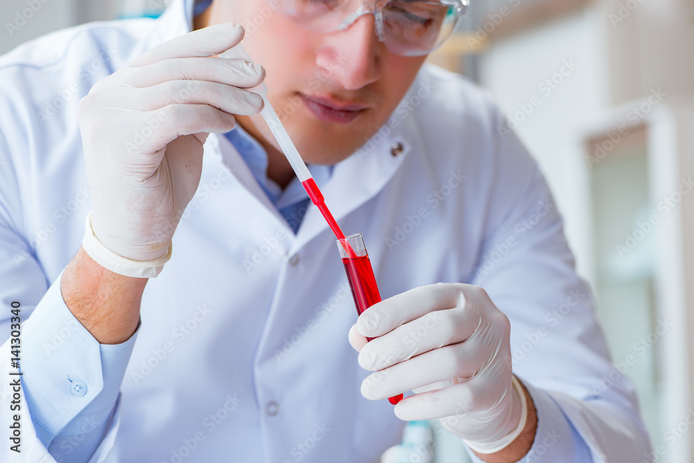 Young doctor working on blood test in lab hospital Young doctor working on blood test in lab hospital