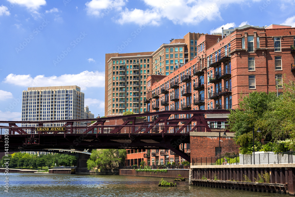 Apartment buildings and the Grand Avenue bridge in the River North district of Chicago on a bright summer day.