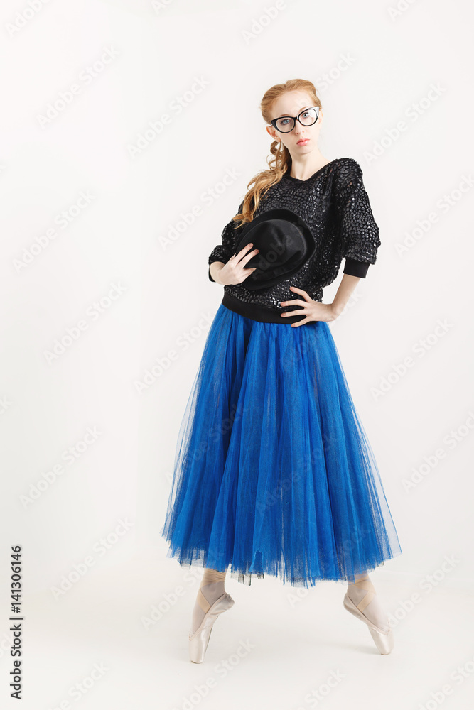Sweet hipster ballerina in a tutu, pointe shoes and glasses dancing with a hat. Modern dance. Sweet hipster ballerina in a tutu, pointe shoes and glasses dancing with a hat. Modern dance.