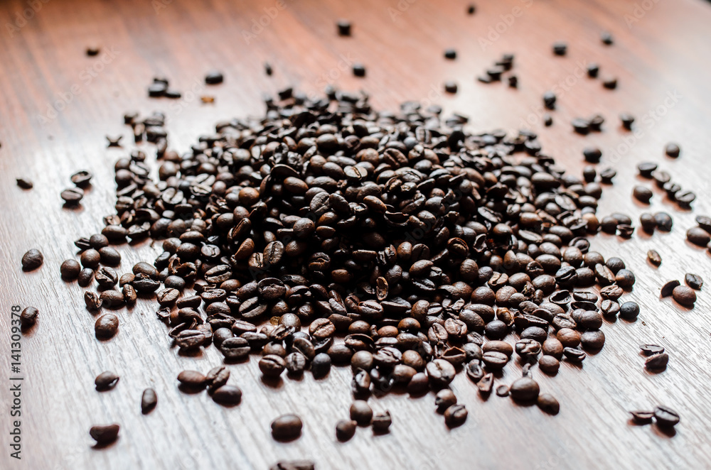 Coffee beans scattered on the table Coffee beans scattered on the table