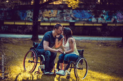 Handicapped couple in wheelchair relaxing in spring park. © Fxquadro