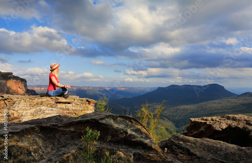 Woman peaceful yoga on mountain summit