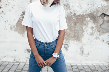 Model posing in plain tshirt against street wall