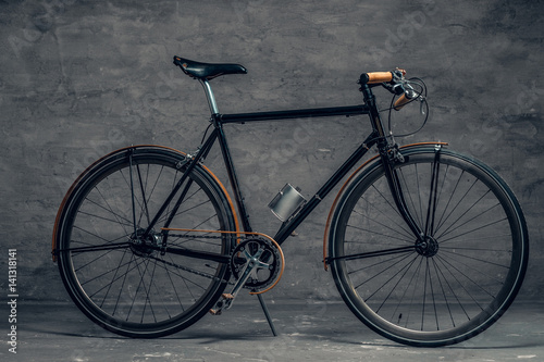 An authentic vintage single speed bicycle over grey background. © Fxquadro