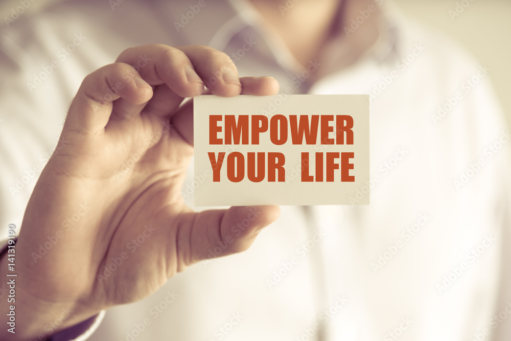 Businessman holding EMPOWER YOUR LIFE message card Businessman holding EMPOWER YOUR LIFE message card
