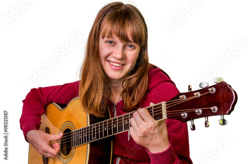 Young girl playing acoustic guitar - isolated on white